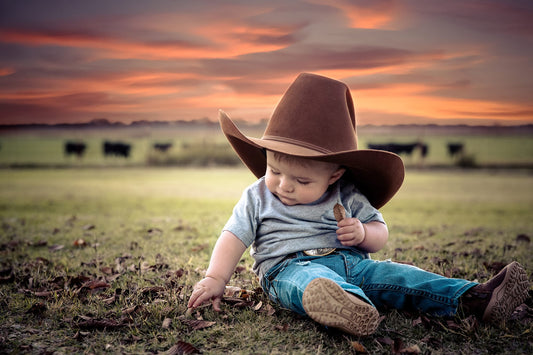 Toddler boy in brown cowboy hat